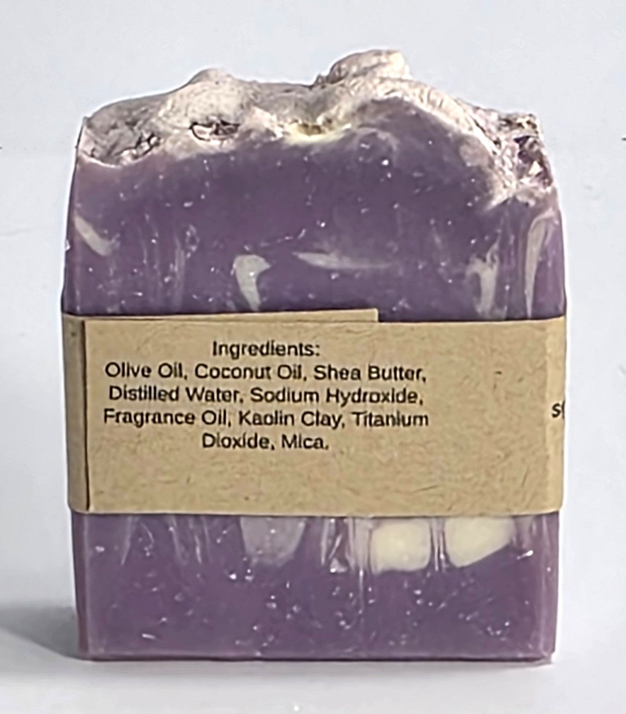Ingredient list label on the back of a handmade Lavender Sky artisan soap bar featuring nourishing olive oil, shea butter, and coconut oil.