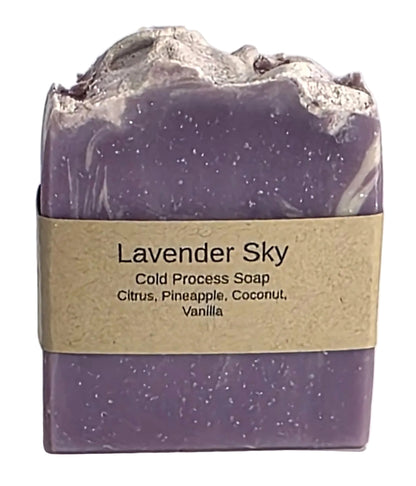 Lavender Sky cold process natural soap bar with brown paper label detailing tropical scent notes of citrus, pineapple, coconut, and vanilla from Smell Good Candles in Fruitland, Iowa.