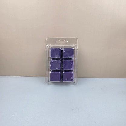 Pack of purple wax melts in a clear plastic packaging on a beige and white background