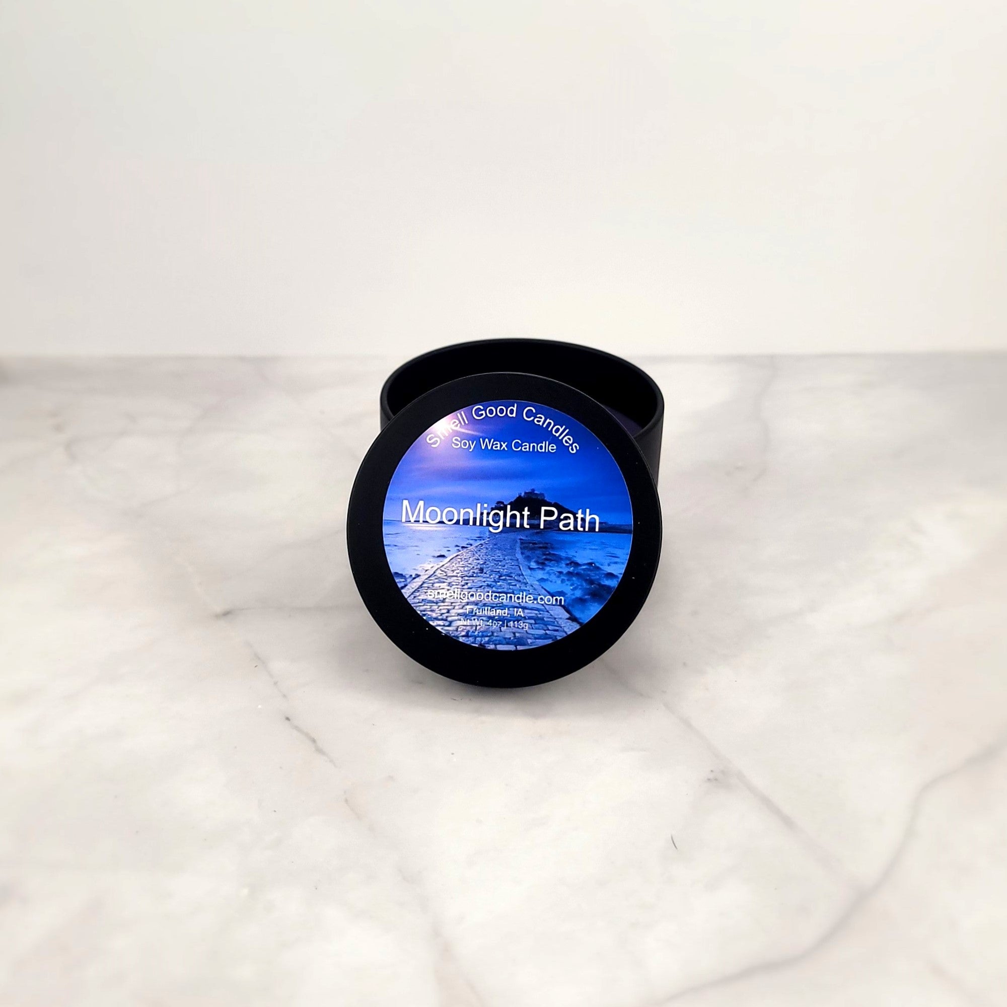 Moonlight Path 4oz soy candle with floral arrangement.