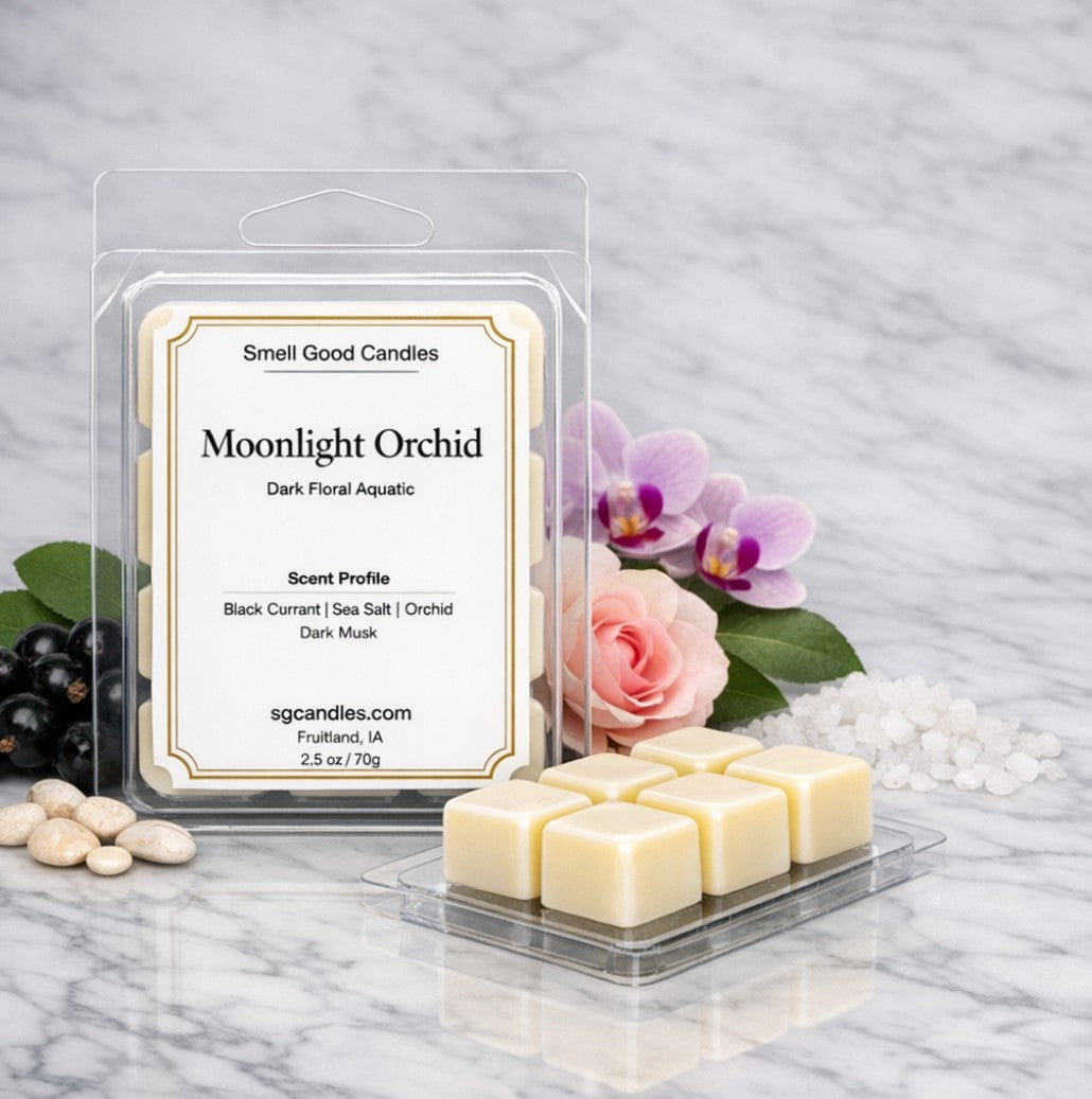 Moonlight Orchid soy wax melt by Smell Good Candles on a white marble surface, featuring dark floral aquatic notes of black currant, sea salt, orchid, and dark musk, shown with white wax melt cubes