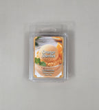 Packaged orange sherbet scented wax melt on a gray background