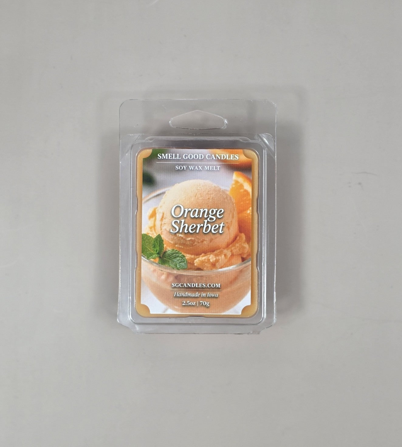 Packaged orange sherbet scented wax melt on a gray background
