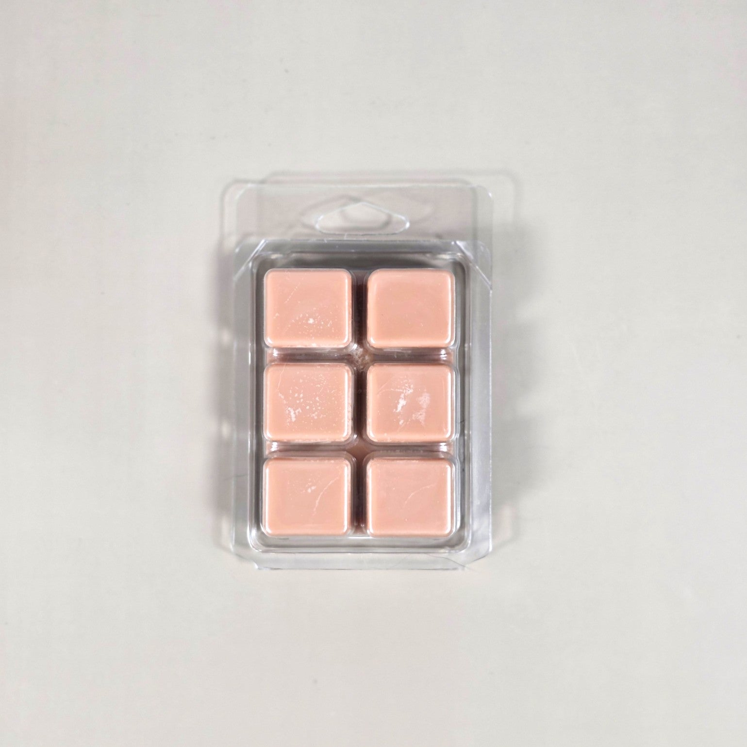 Clear 6-cavity clamshell packaging showcasing dark gray, hand-poured soy wax melt cubes for home fragrance warmers.