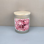 Frosted glass candle with peppermint label on a neutral background