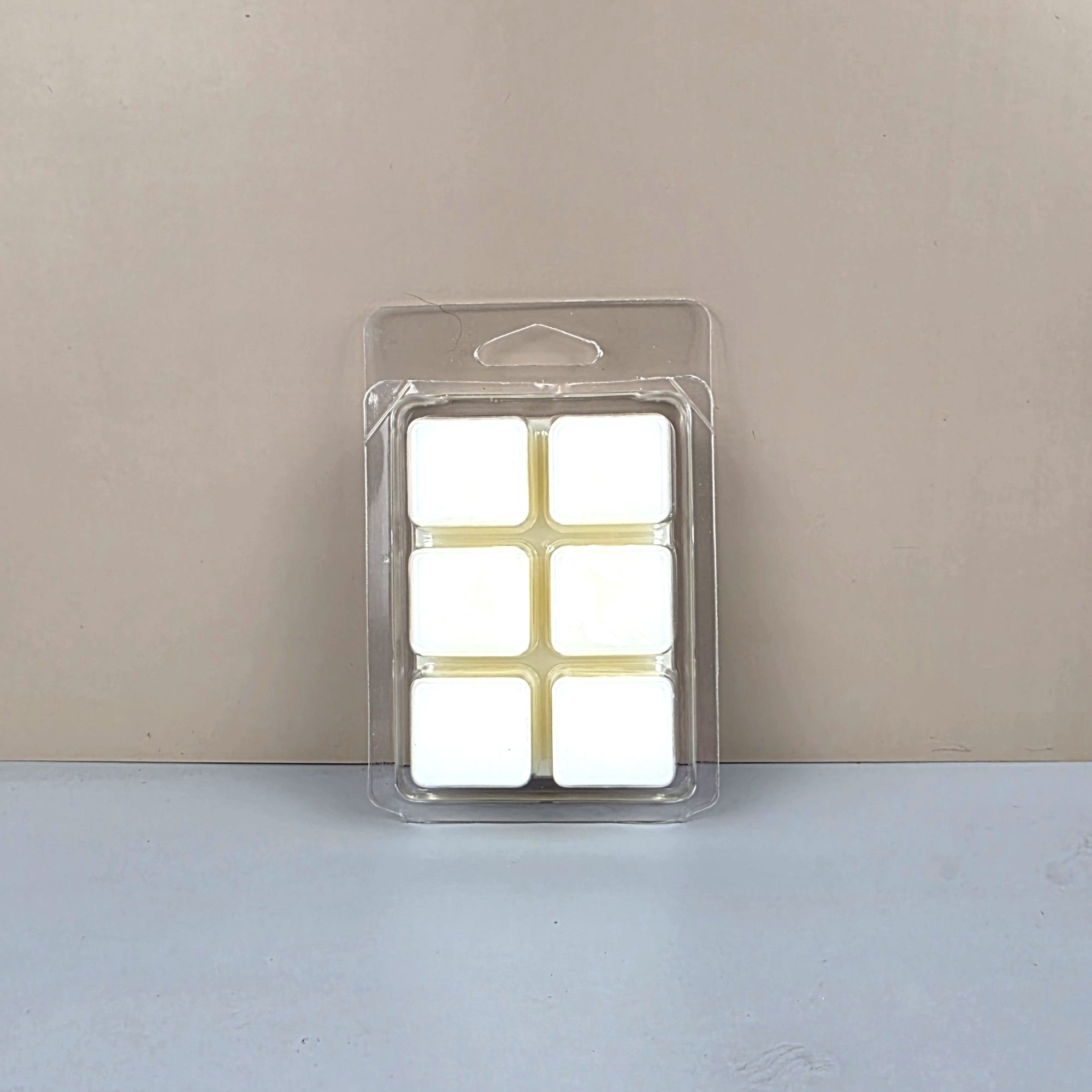 Packaged white square filters on a beige background