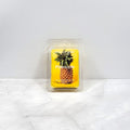 Pineapple-themed wax melt packaging on a white surface