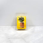 Pineapple-themed wax melt packaging on a white surface