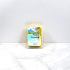 Wax melt container labeled 'Pure Paradise' on a white background