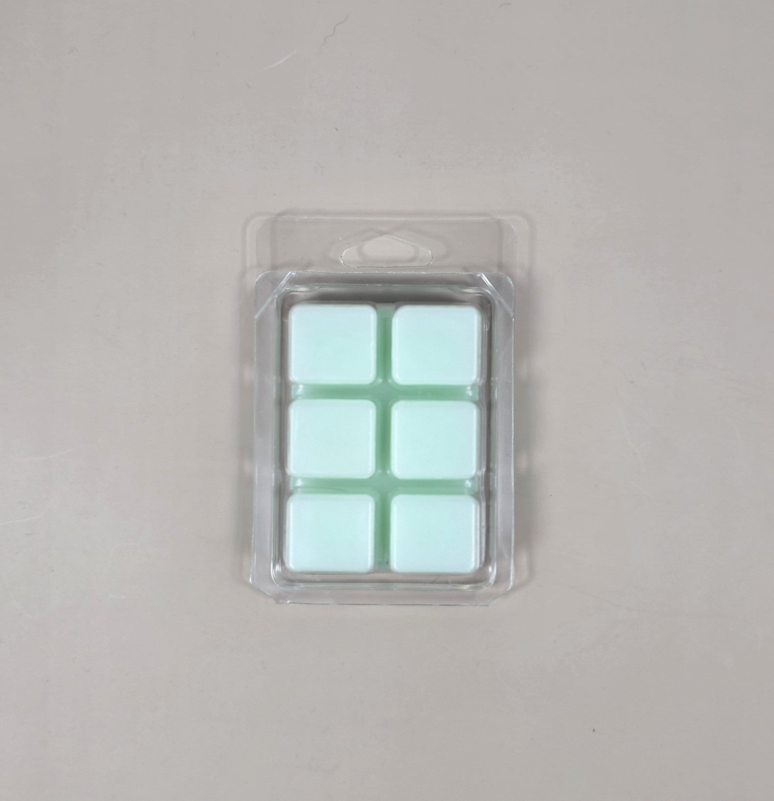 Packaged product with six square compartments on a gray background
