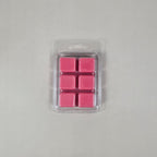 Pack of pink wax melts in a clear plastic packaging on a gray background