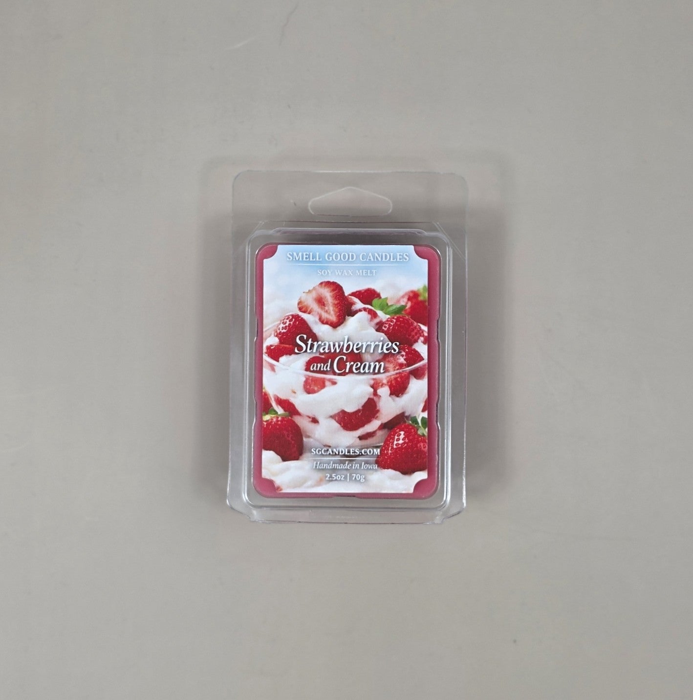 Strawberries and Cream wax melt package on a gray background