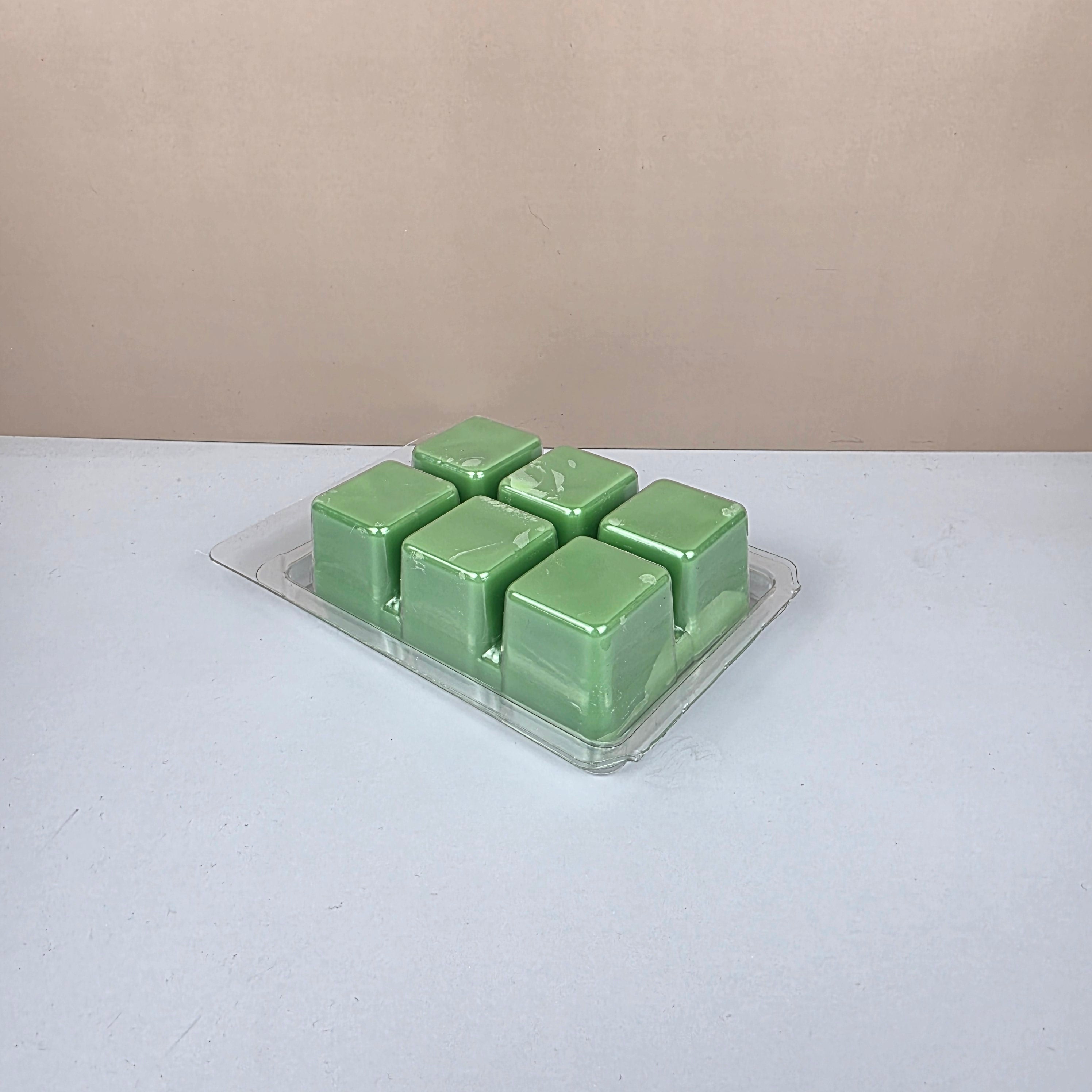 Pack of green wax melts on a white background