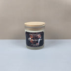 Candle in a glass jar with a wooden lid on a neutral background