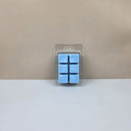 Packaged blue wax cubes on a beige background