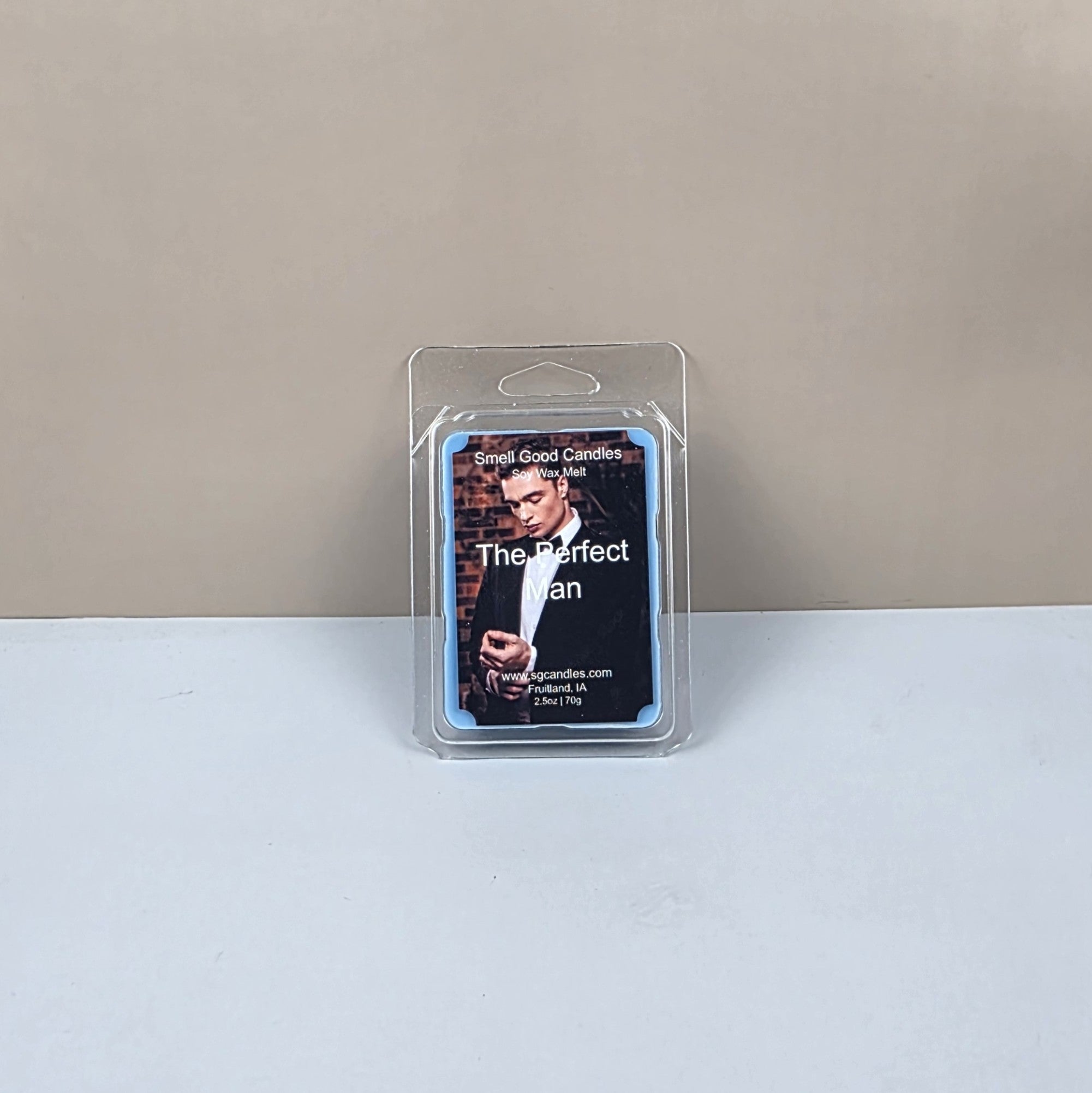 Packaged candle labeled 'The Perfect Man' on a plain background