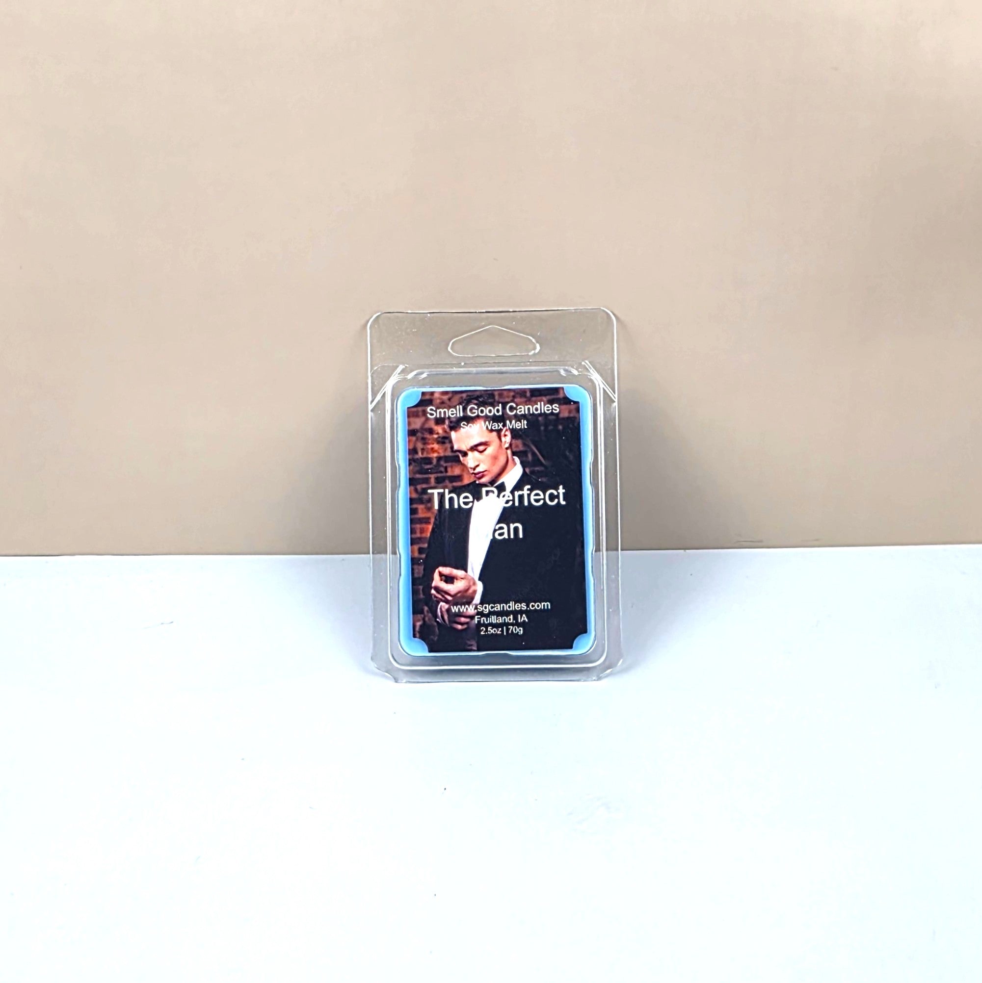 Packaged candle labeled 'The Perfect Man' on a beige background