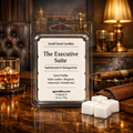 Luxury white soy wax melts in clamshell packaging labeled “The Executive Suite” by Smell Good Candles, displayed on a rich wood desk with white wax melt cubes, leather, and warm executive office décor.