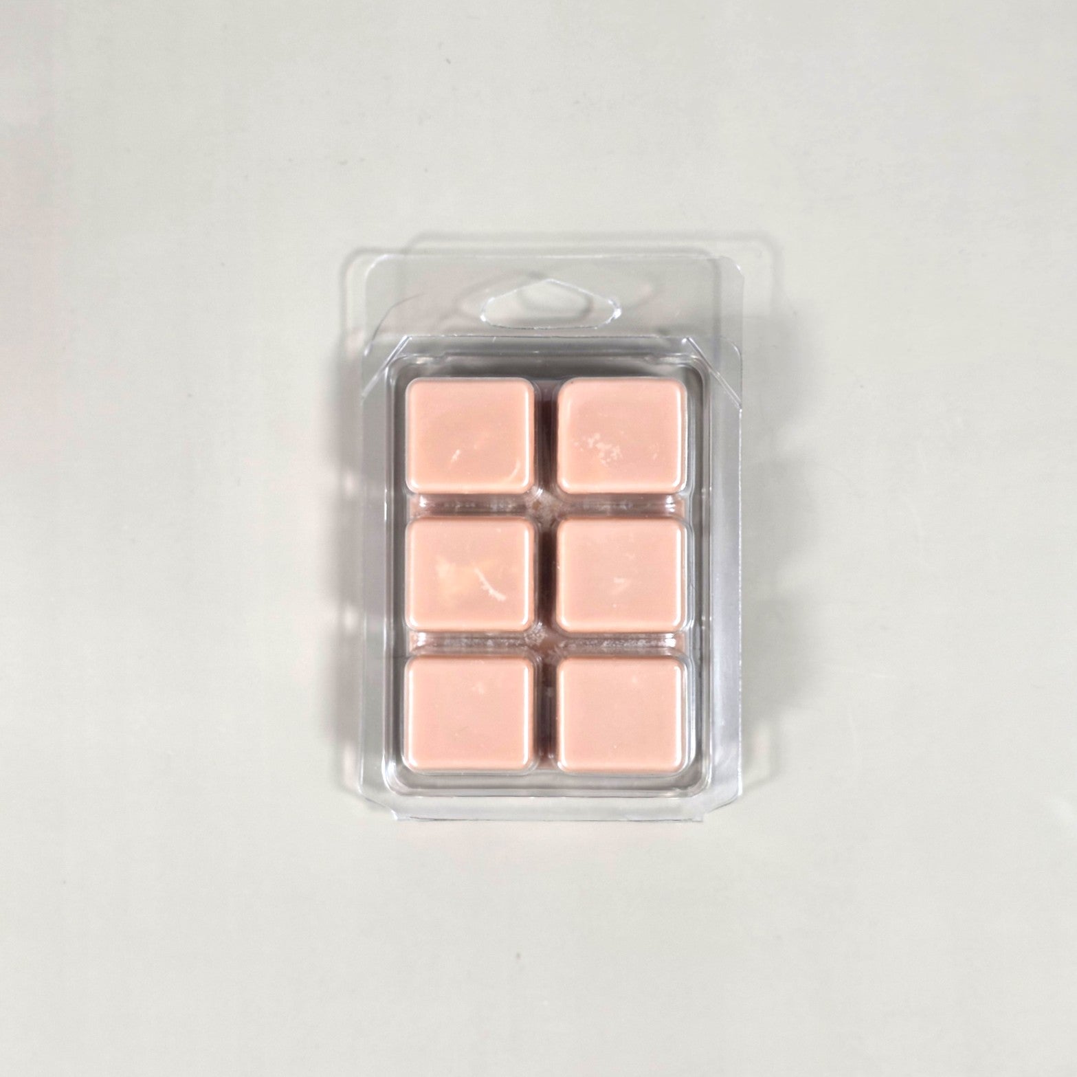 Clear 6-cavity clamshell packaging featuring off-white, hand-poured soy wax melt cubes for home fragrance warmers.
