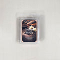 Labeled Tobacco Vanilla soy wax melt in a 2.5oz clamshell with a luxury label depicting a glass of bourbon and dried tobacco leaves.