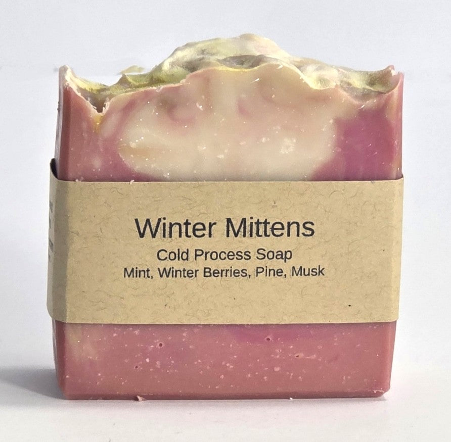 Winter Mittens cold process natural soap bar with brown paper label featuring notes of mint, winter berries, pine, and musk from Smell Good Candles in Fruitland, Iowa.