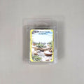 Labeled Wood Sage & Sea Salt soy wax melt in a 2.5oz clamshell featuring a peaceful coastal scene with driftwood and ocean waves.
