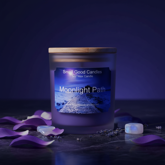 Moonlight Path soy candle by Smell Good Candles styled in a moody romantic scene with moonstone crystals, purple petals, and dried lavender